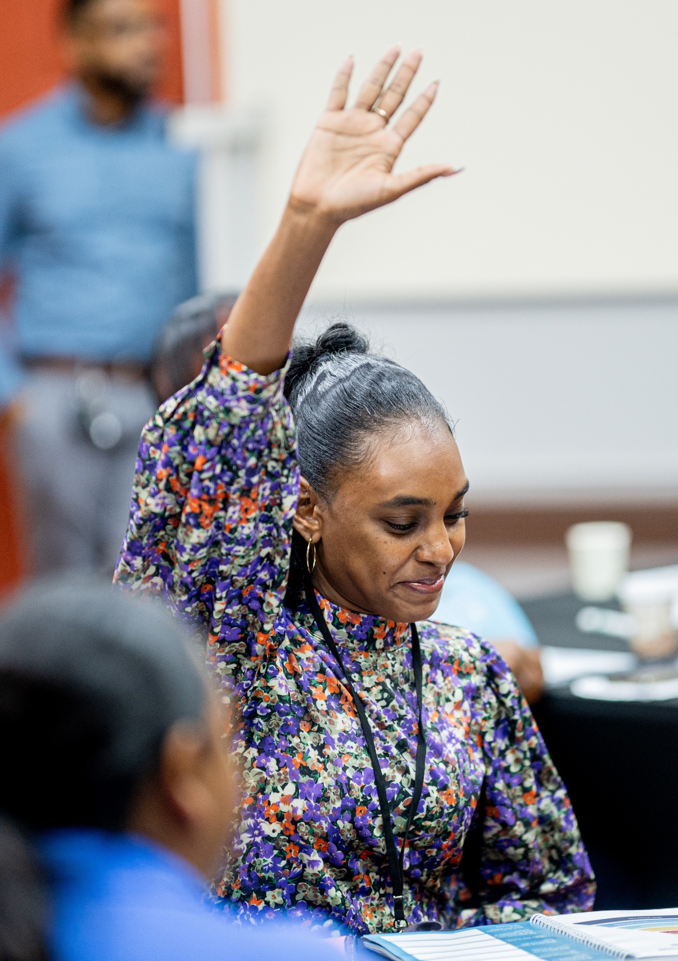 Unlock Your Potential attendee raising her hand